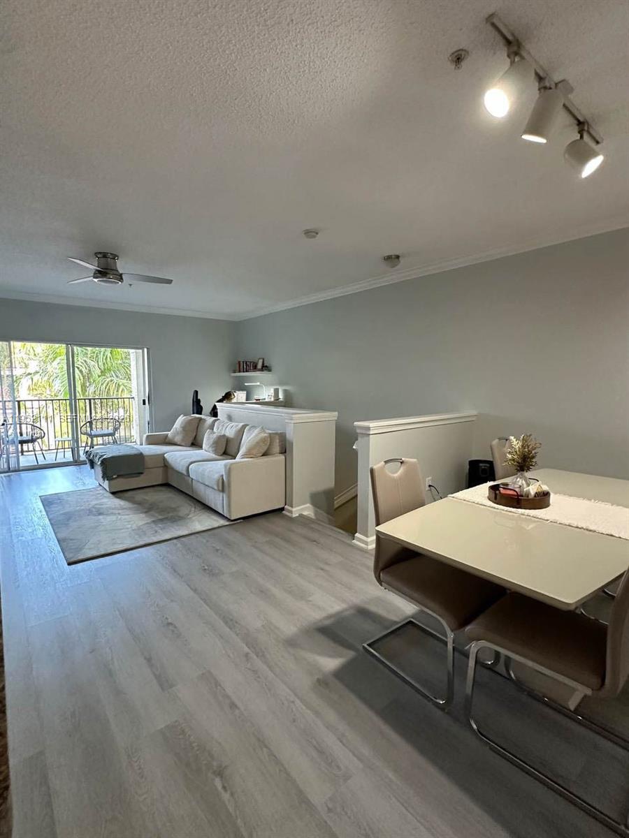 5840 West Sample Road, Unit 305 Coral Springs, FL 33067 - Photo 13 of 38 a living room with furniture and window