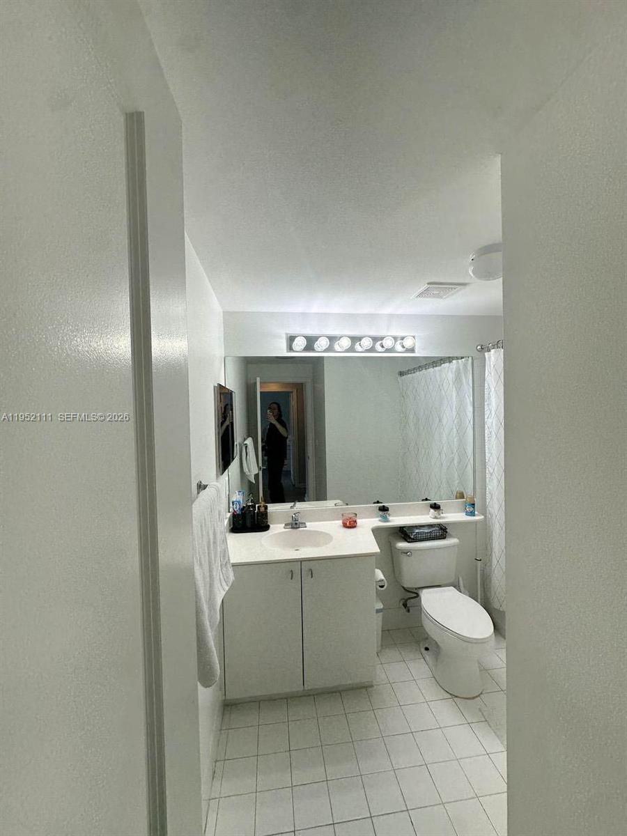 5840 West Sample Road, Unit 305 Coral Springs, FL 33067 - Photo 14 of 38 a room with a table chairs and mirrors
