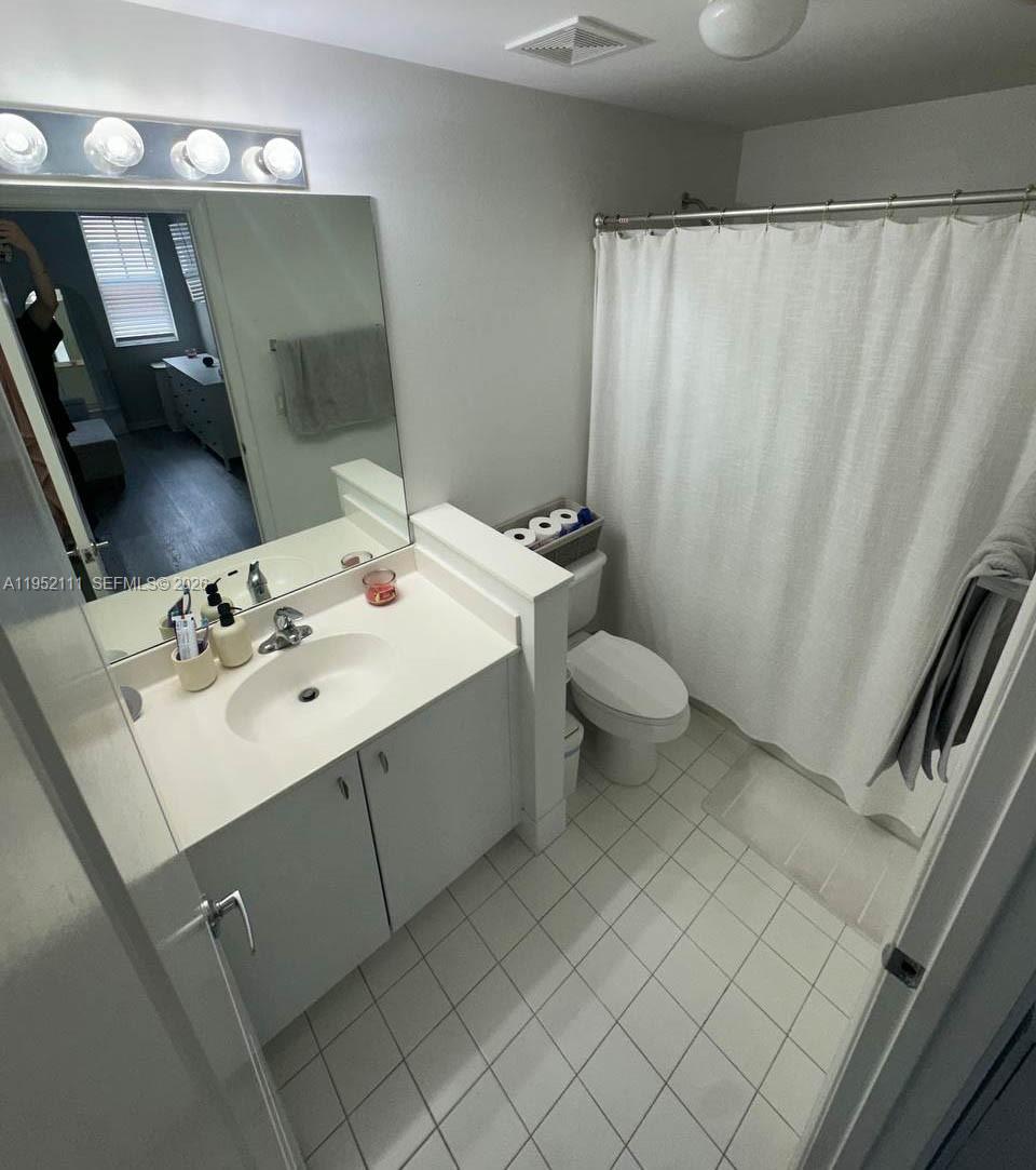 5840 West Sample Road, Unit 305 Coral Springs, FL 33067 - Photo 19 of 38 a bathroom with a sink toilet and shower