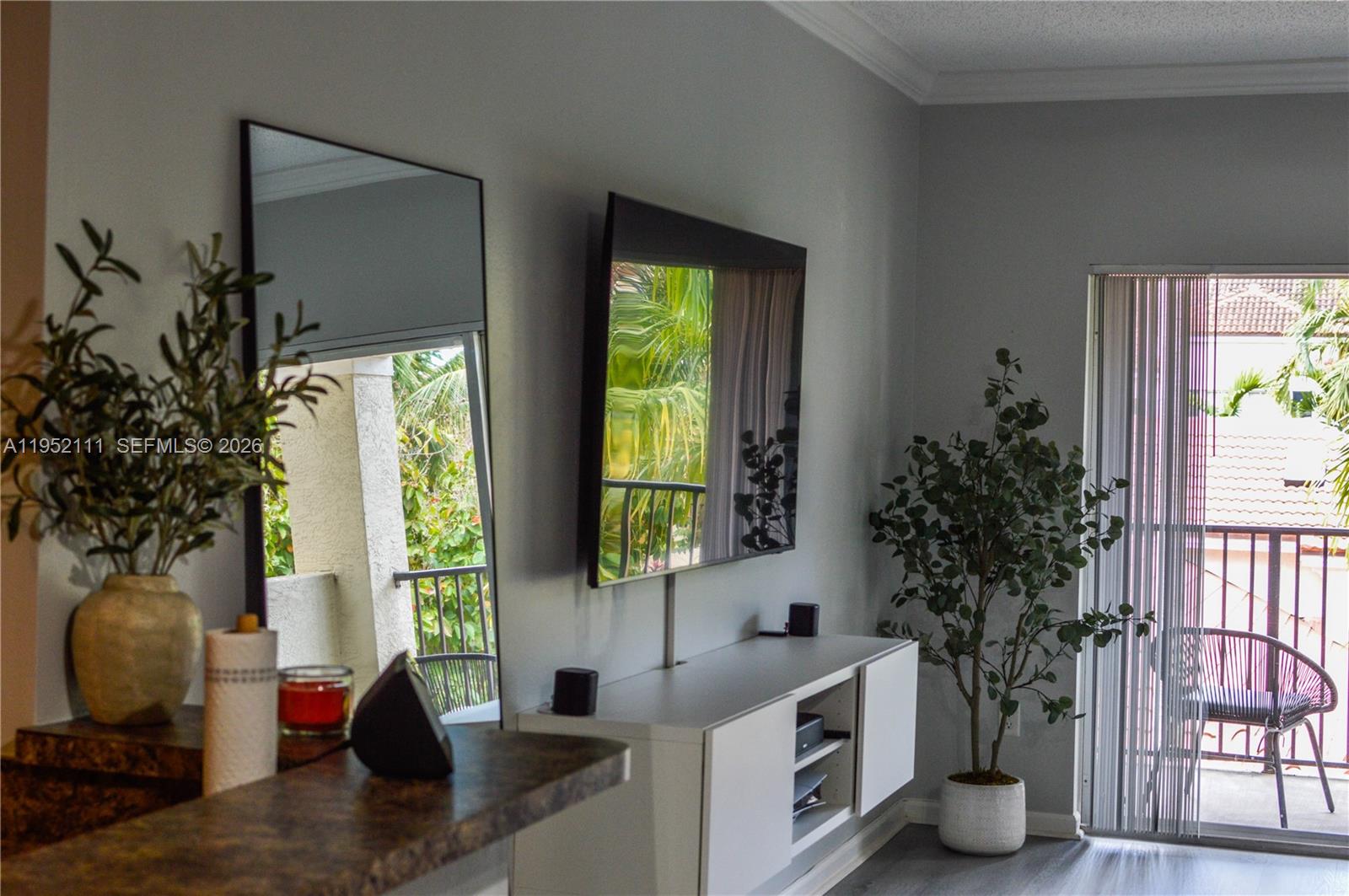 5840 West Sample Road, Unit 305 Coral Springs, FL 33067 - Photo 2 of 38 a living room with furniture and a potted plant