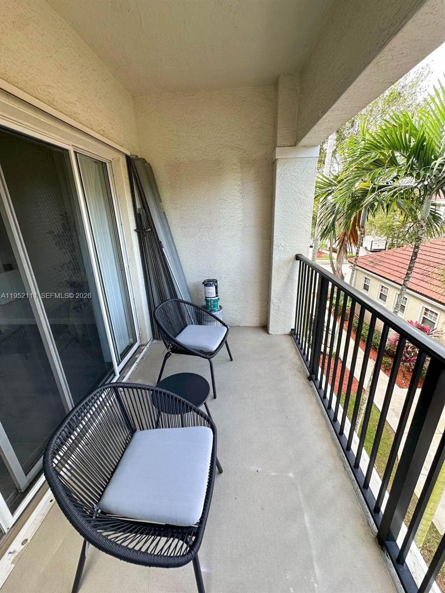 5840 West Sample Road, Unit 305 Coral Springs, FL 33067 - Photo 22 of 38 a view of balcony with furniture