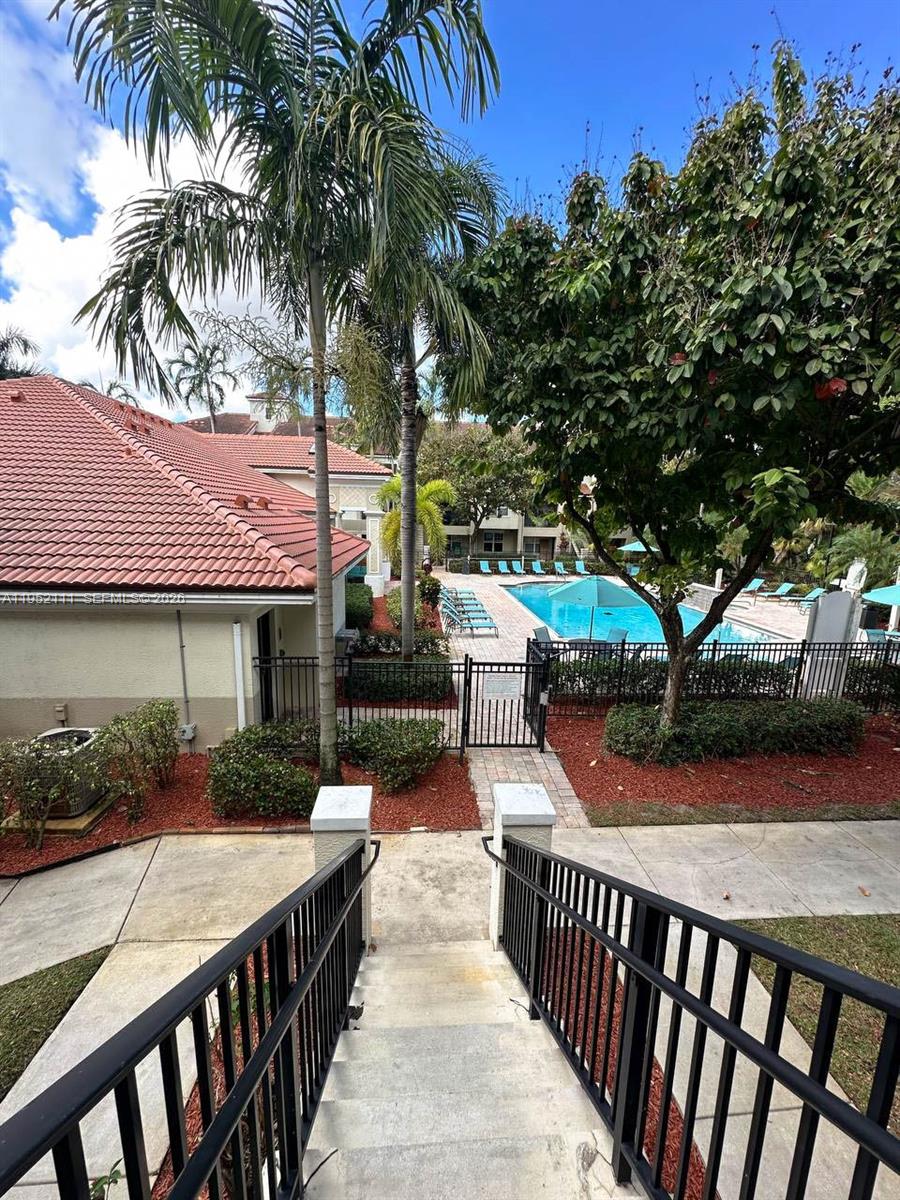5840 West Sample Road, Unit 305 Coral Springs, FL 33067 - Photo 24 of 38 a view of a house with backyard and sitting area