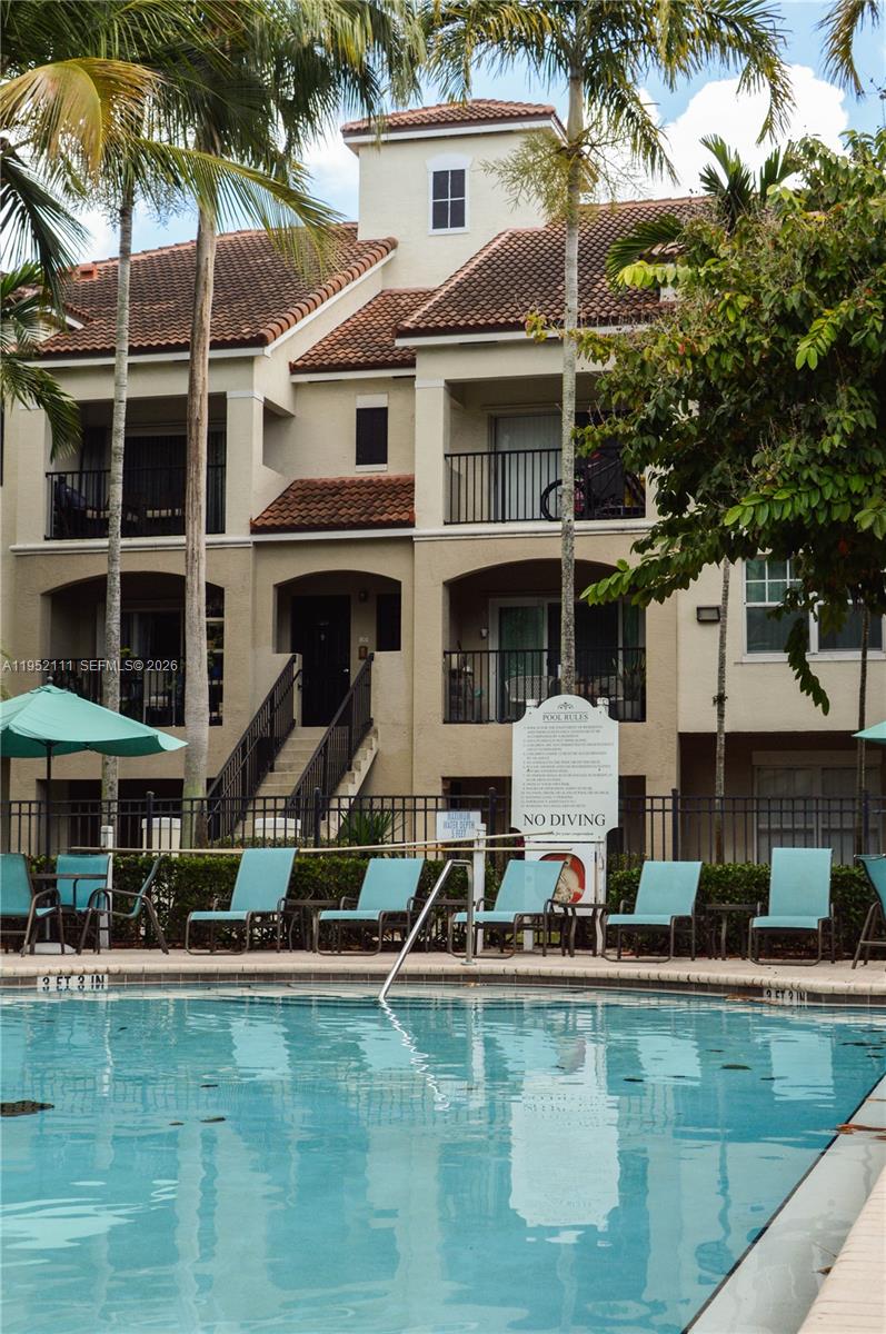 5840 West Sample Road, Unit 305 Coral Springs, FL 33067 - Photo 26 of 38 a view of a building with a swimming pool