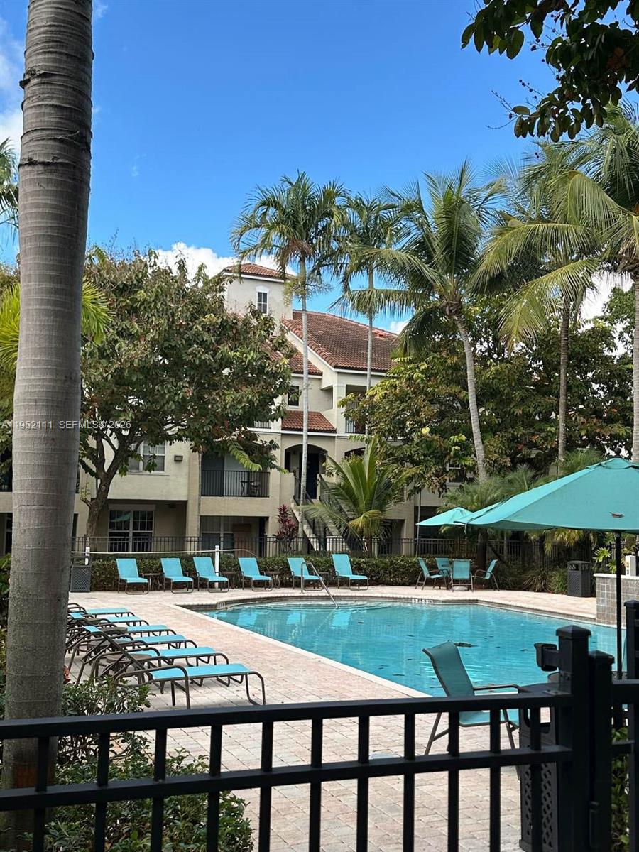 5840 West Sample Road, Unit 305 Coral Springs, FL 33067 - Photo 30 of 38 a view of an chairs and table in the patio