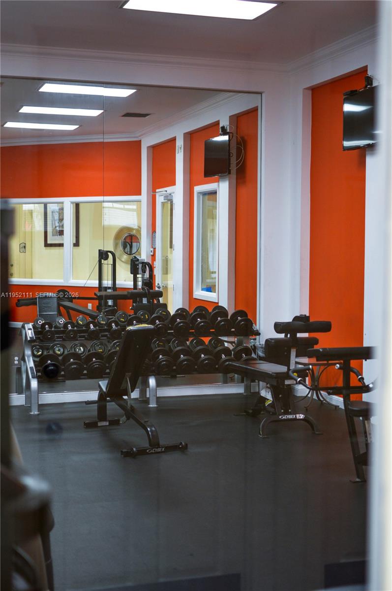 5840 West Sample Road, Unit 305 Coral Springs, FL 33067 - Photo 31 of 38 a view of a room with gym equipment