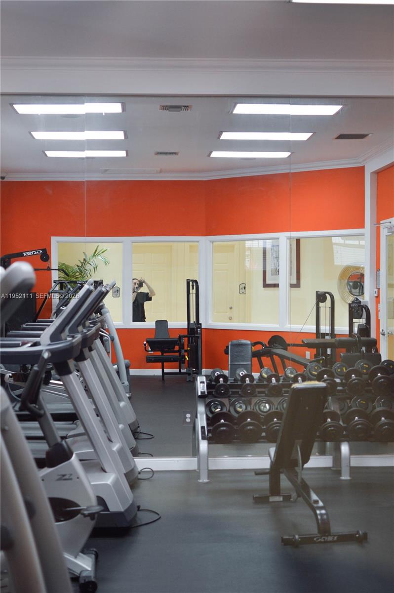 5840 West Sample Road, Unit 305 Coral Springs, FL 33067 - Photo 33 of 38 a room with lots of gym equipment