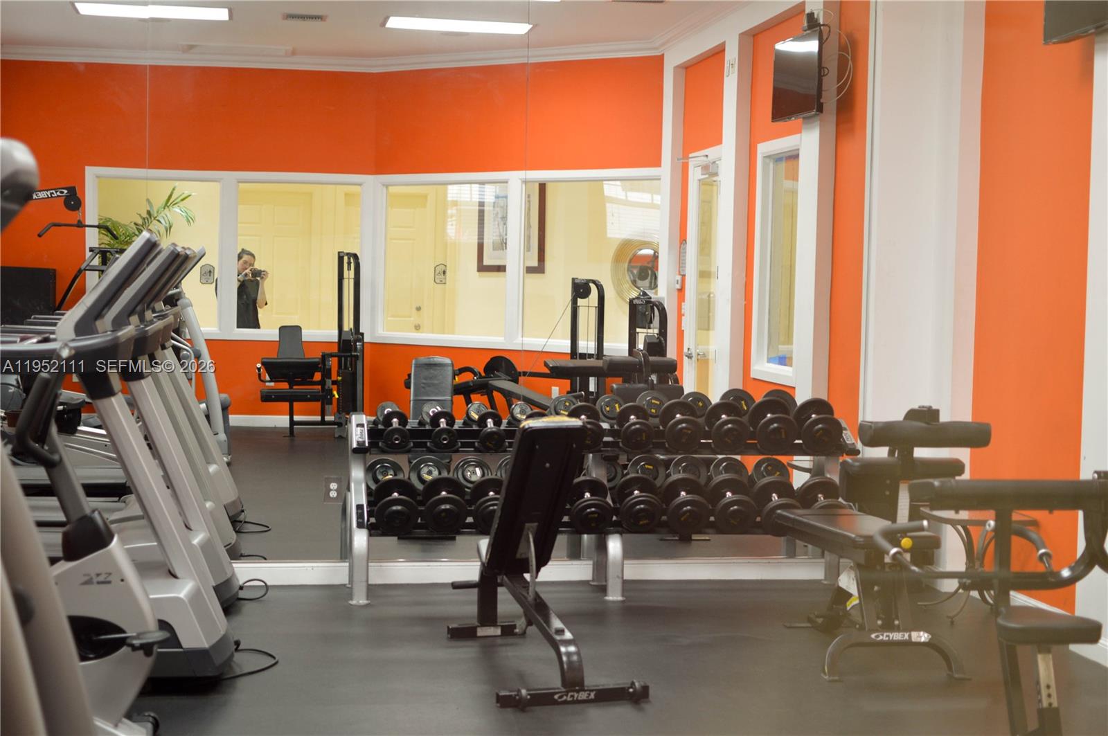 5840 West Sample Road, Unit 305 Coral Springs, FL 33067 - Photo 34 of 38 a living room with large windows and furniture