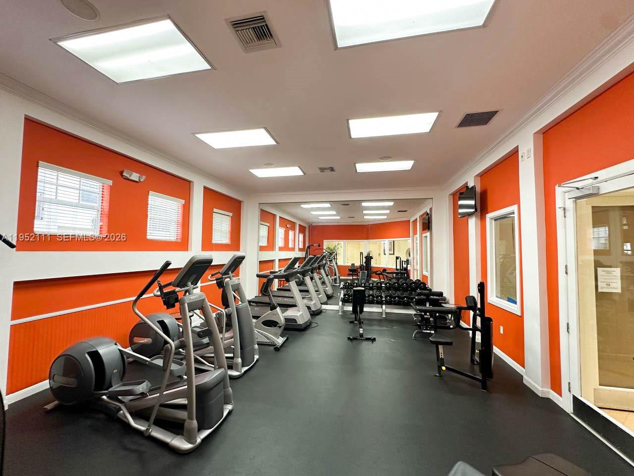 5840 West Sample Road, Unit 305 Coral Springs, FL 33067 - Photo 36 of 38 a view of a room with gym equipment
