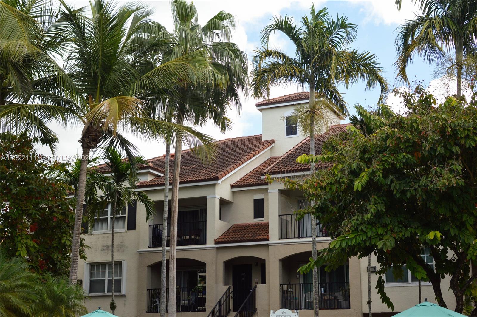 5840 West Sample Road, Unit 305 Coral Springs, FL 33067 - Photo 38 of 38 a front view of a house with a tree
