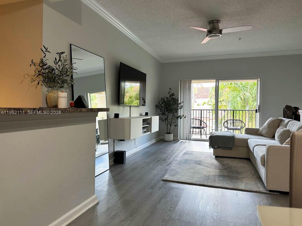 5840 West Sample Road, Unit 305 Coral Springs, FL 33067 - Photo 5 of 38 a living room with furniture and a large window