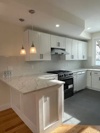 a kitchen with a stove sink and cabinets