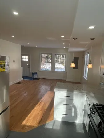 a view of a room with window and wooden floor
