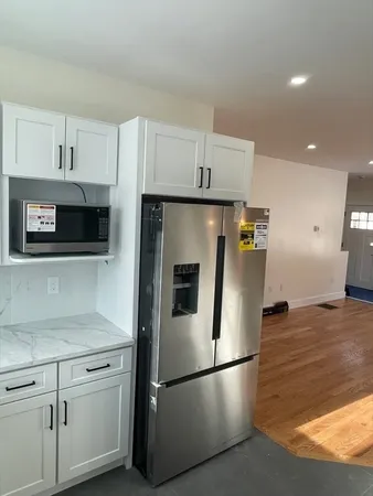 a kitchen with stainless steel appliances a refrigerator sink and microwave
