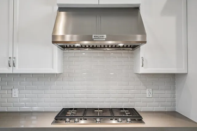 a stove top oven sitting inside of a kitchen