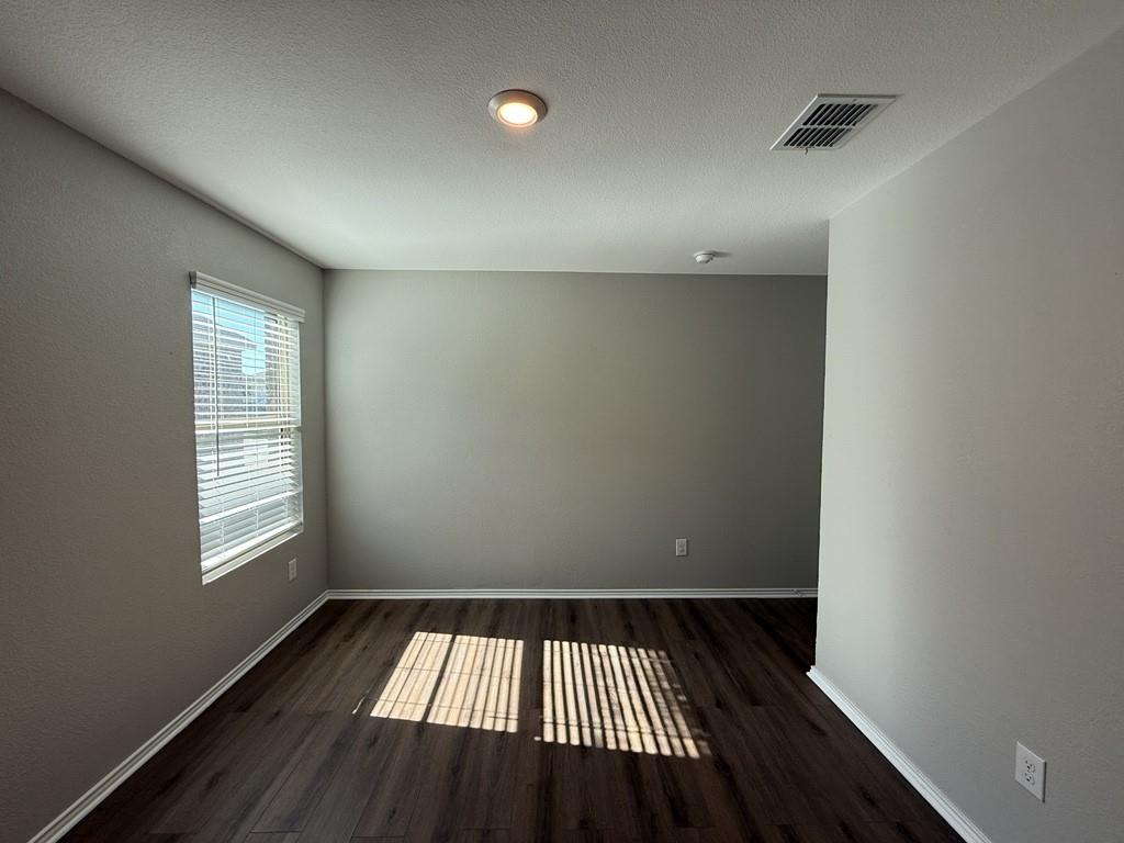 413 Everglades Street Princeton, TX 75407 - Photo 20 of 39 wooden floor in an empty room with a window