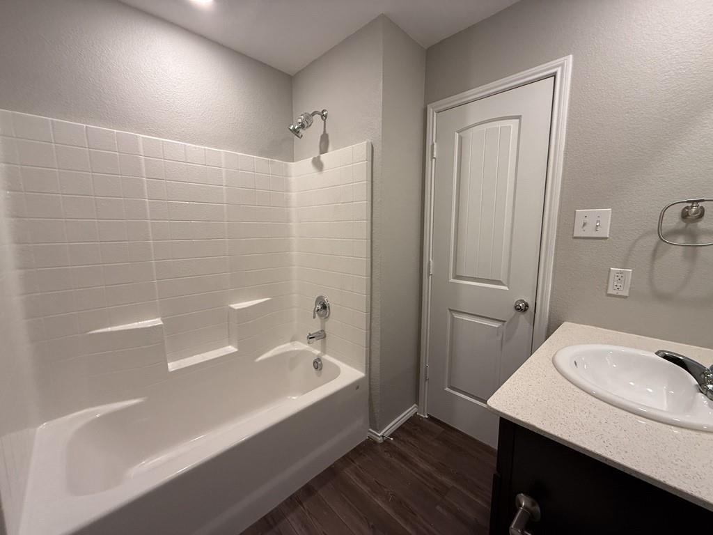 413 Everglades Street Princeton, TX 75407 - Photo 28 of 39 a bathroom with a sink a bathtub and a mirror