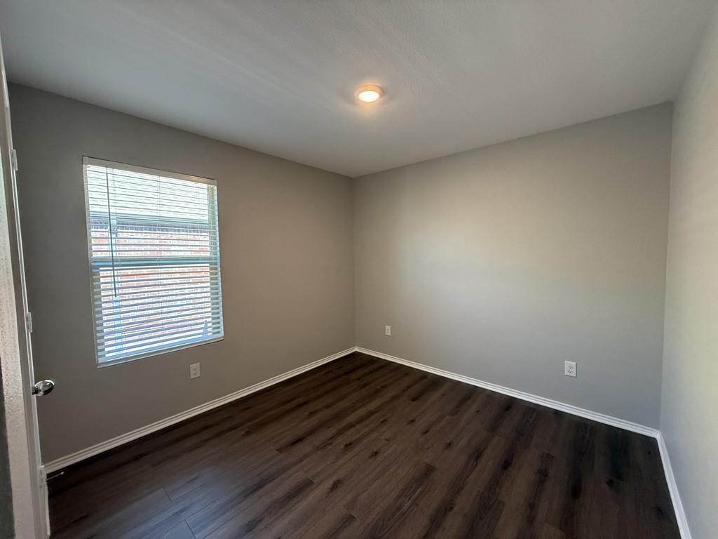413 Everglades Street Princeton, TX 75407 - Photo 29 of 39 an empty room with wooden floor and windows