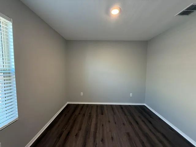 a view of small space with wooden floor and windows