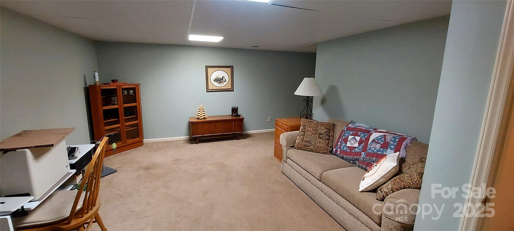 128 Ridgewood Way, Unit 208 Marion, NC 28752 - Photo 12 of 17 a living room with furniture and a flat screen tv