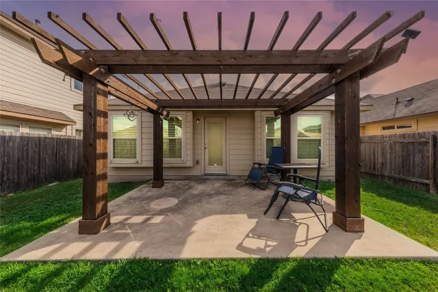 a view of a porch with furniture and garden