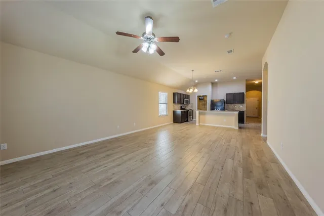 a view of kitchen and hall with wooden floor
