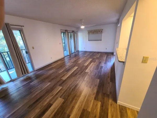 a view of a room with wooden floor and staircase