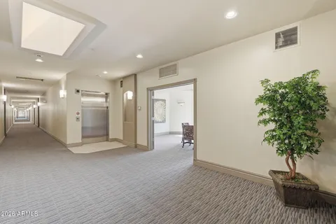 a view of hallway with bathroom