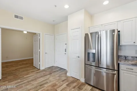 a kitchen with stainless steel appliances granite countertop a refrigerator and a stove top oven