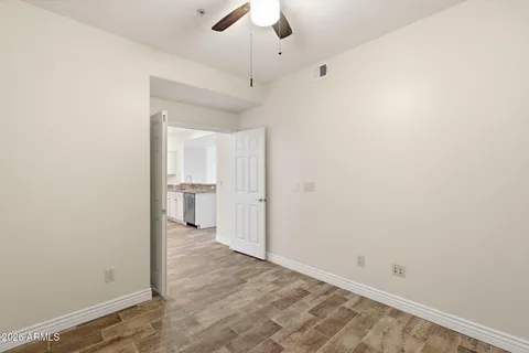 a kitchen with stainless steel appliances a refrigerator and wooden floor