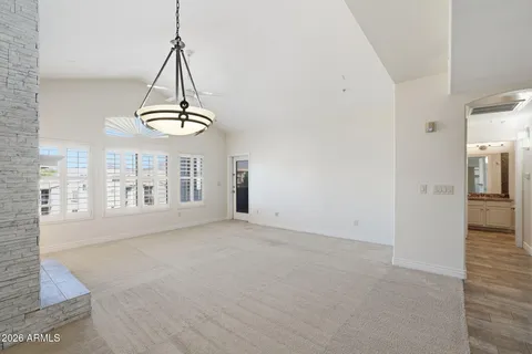 a view of empty room with a fireplace and fan