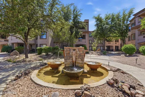 a view of a swimming pool with a lawn chairs and plants
