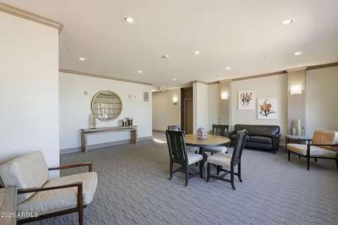 a living room with furniture a dining table and chairs with wooden floor