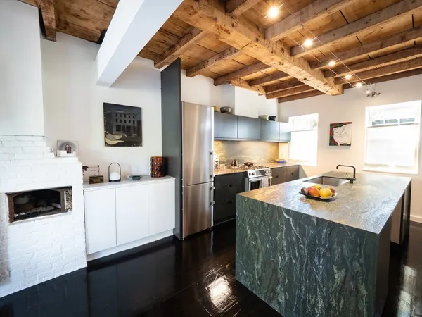 a kitchen with stainless steel appliances granite countertop a sink a stove and a refrigerator