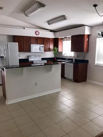 a kitchen with stainless steel appliances granite countertop a sink and a stove