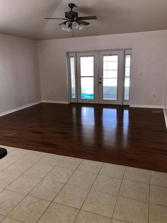 7019 Belt Link Loop Wesley Chapel, FL 33545 - Photo 5 of 14 a view of empty room with wooden floor and fan