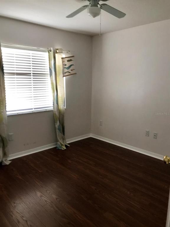 7019 Belt Link Loop Wesley Chapel, FL 33545 - Photo 6 of 14 an empty room with wooden floor and windows