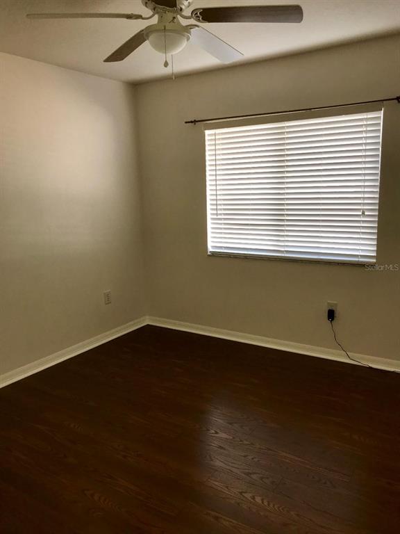 7019 Belt Link Loop Wesley Chapel, FL 33545 - Photo 10 of 14 a view of an empty room with wooden floor and a window