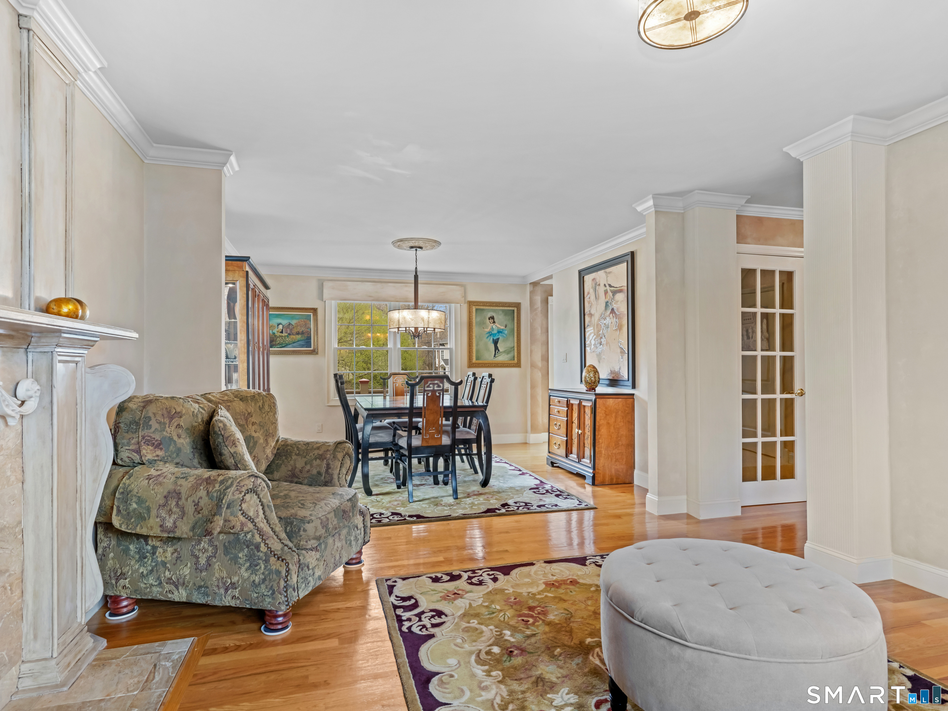 82 Ramapoo Road Ridgefield, CT 06877 - Photo 16 of 40 The beautiful living room features a custom built-in, custom fireplace mantle and gleaming hardwood floors.