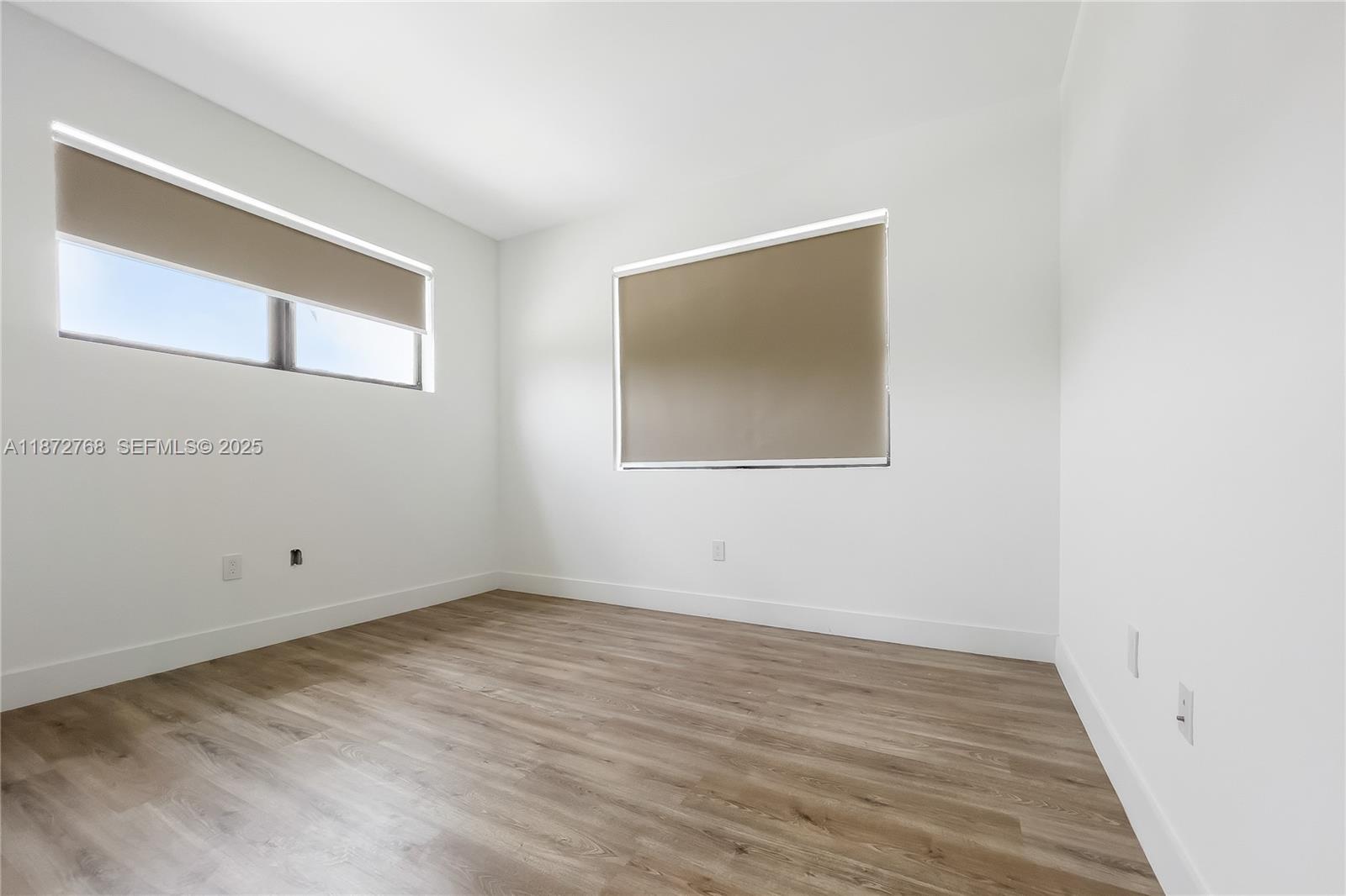 6159 Southwest 36th Court Miramar, FL 33023 - Photo 16 of 28 an empty room with wooden floor and windows