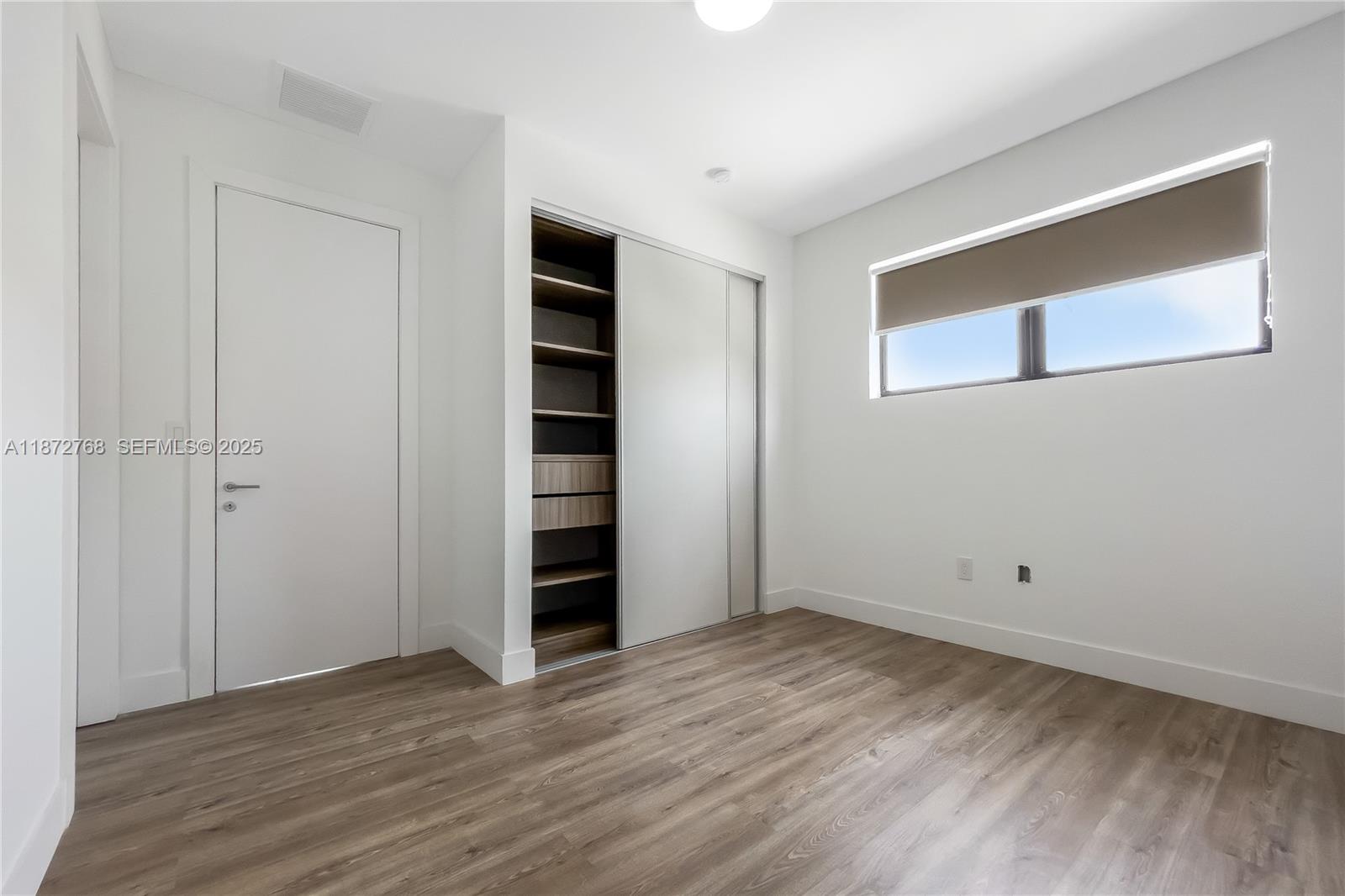 6159 Southwest 36th Court Miramar, FL 33023 - Photo 17 of 28 a view of empty room with wooden floor and entryway