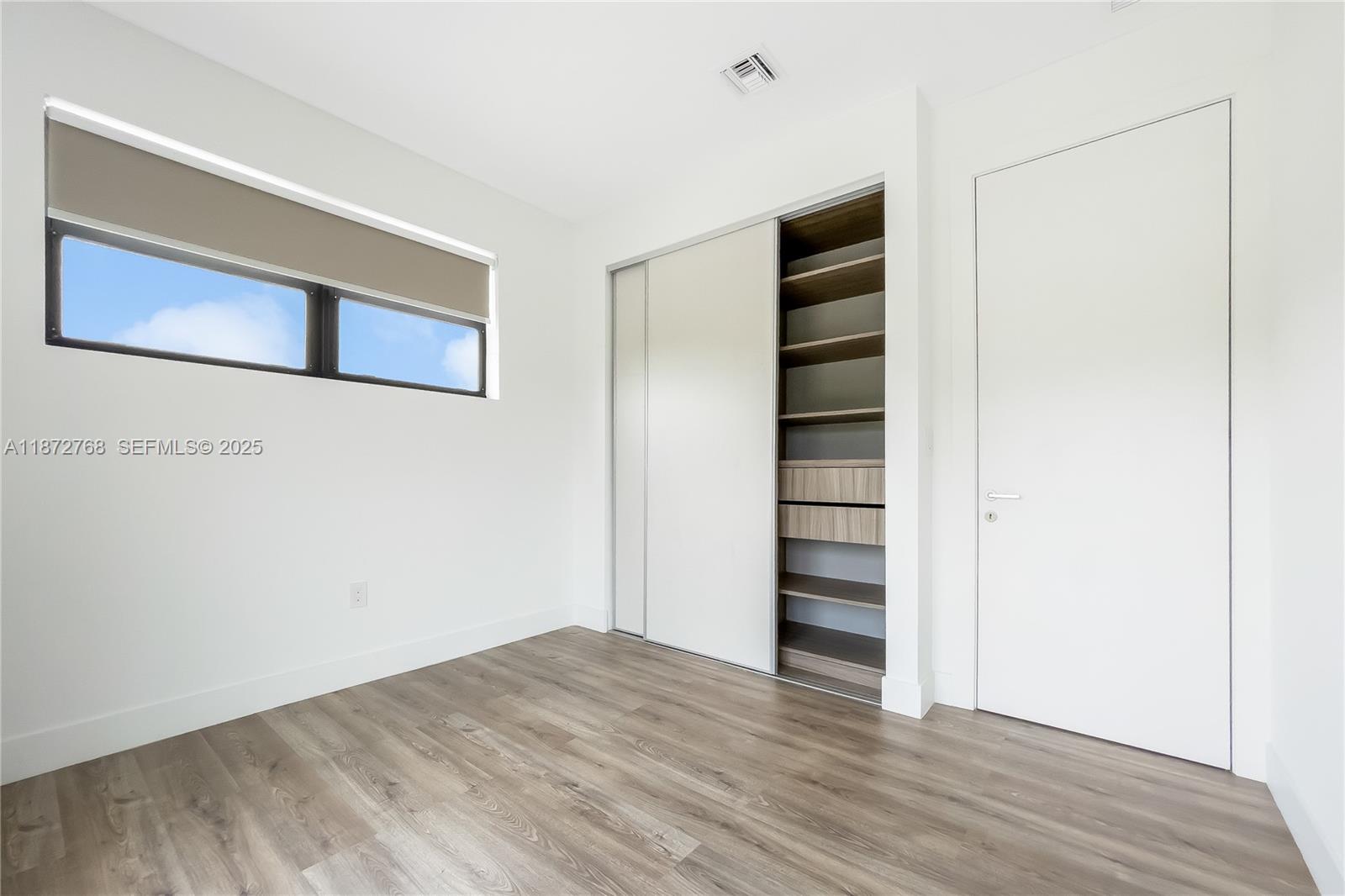 6159 Southwest 36th Court Miramar, FL 33023 - Photo 21 of 28 a view of an empty room with wooden floor