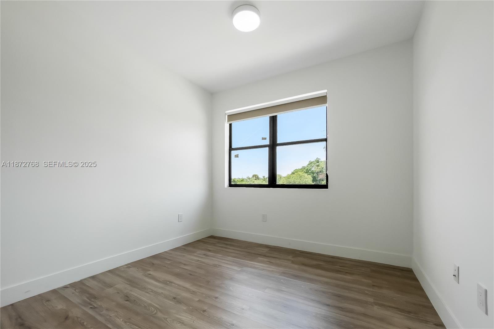 6159 Southwest 36th Court Miramar, FL 33023 - Photo 24 of 28 an empty room with wooden floor and windows