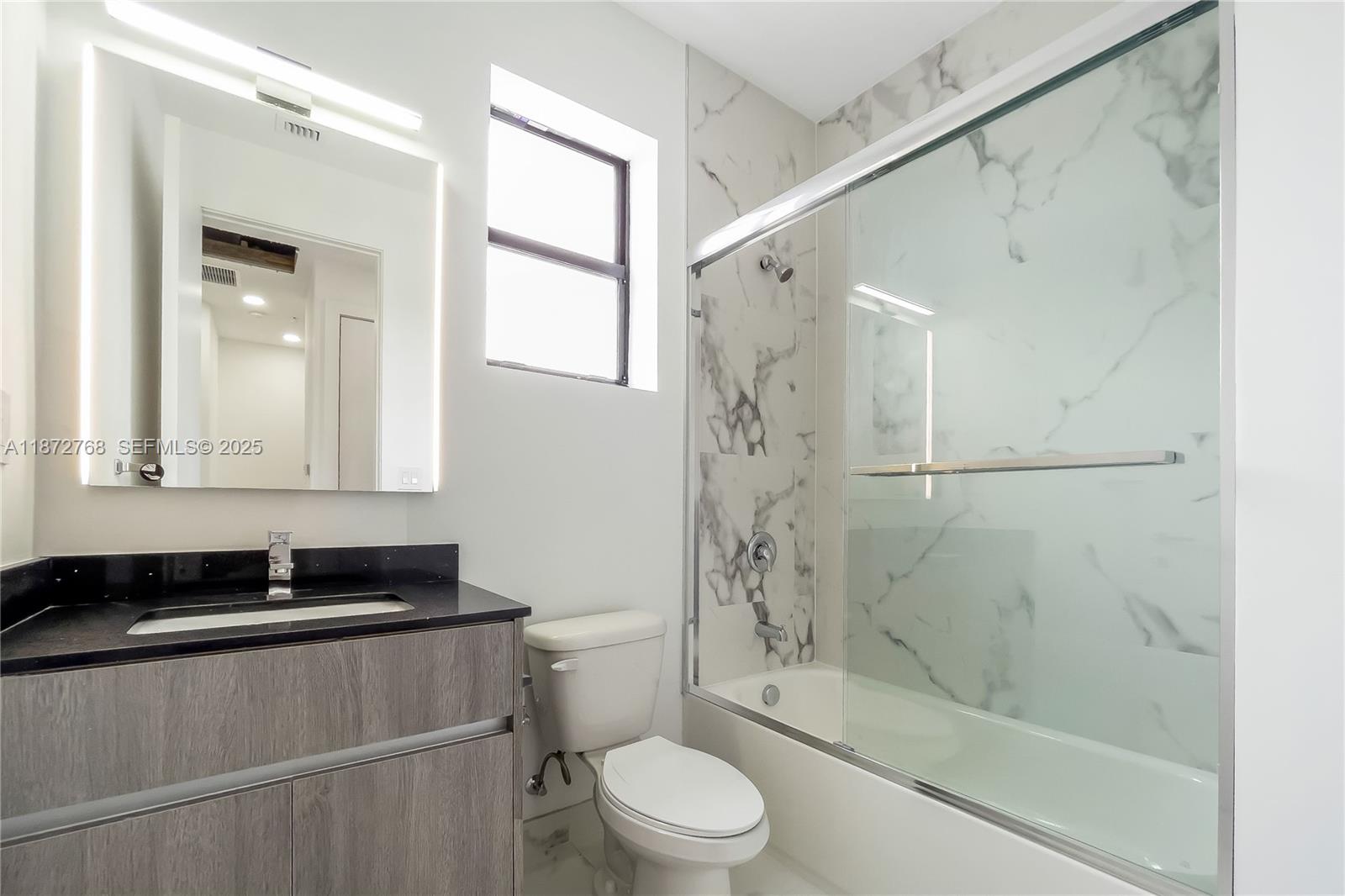 6159 Southwest 36th Court Miramar, FL 33023 - Photo 27 of 28 a bathroom with a granite countertop bathtub shower sink vanity and toilet