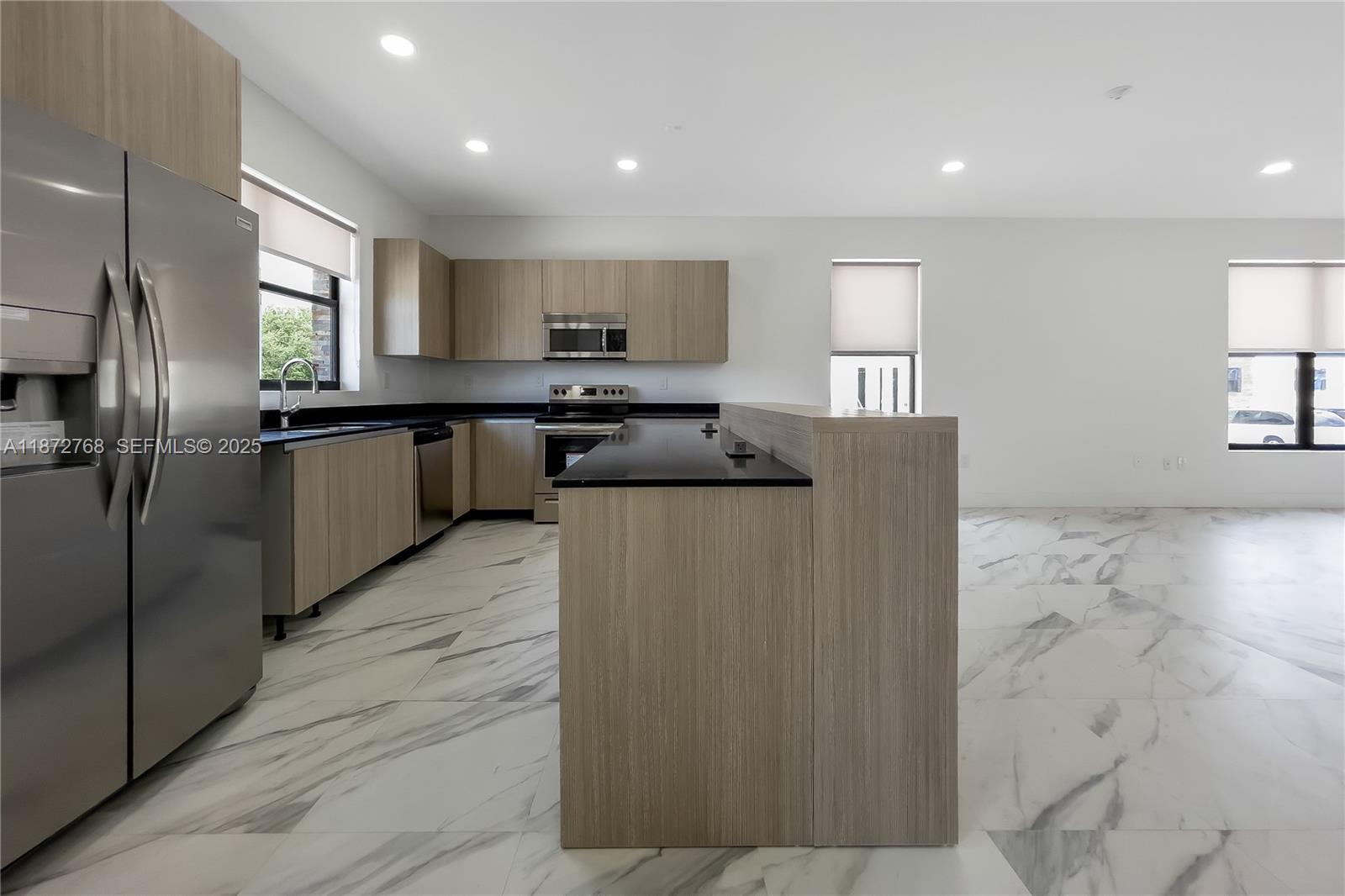 6159 Southwest 36th Court Miramar, FL 33023 - Photo 5 of 28 a kitchen with stainless steel appliances granite countertop a refrigerator a sink and a stove