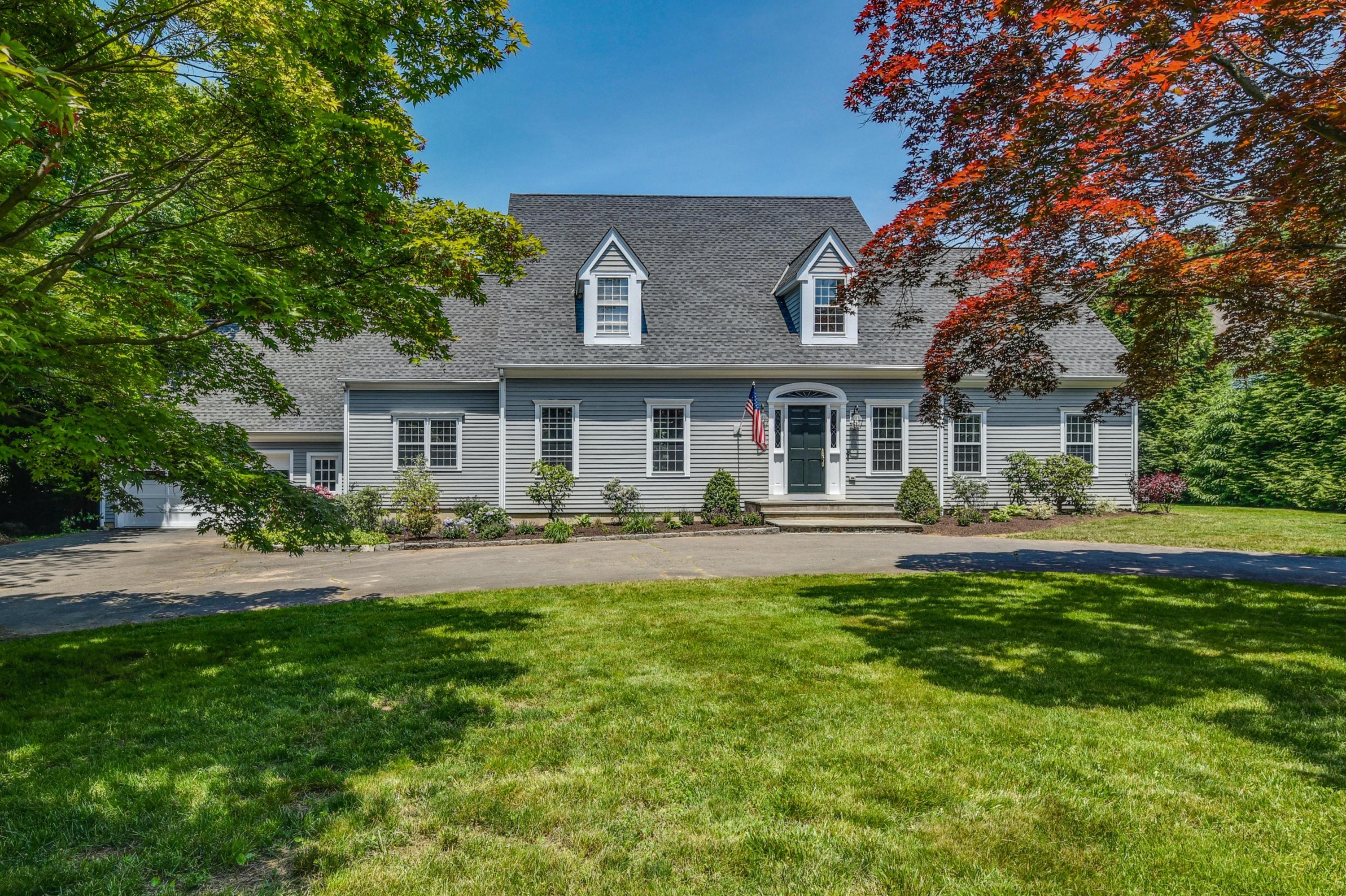 a front view of a house with swimming pool having outdoor seating