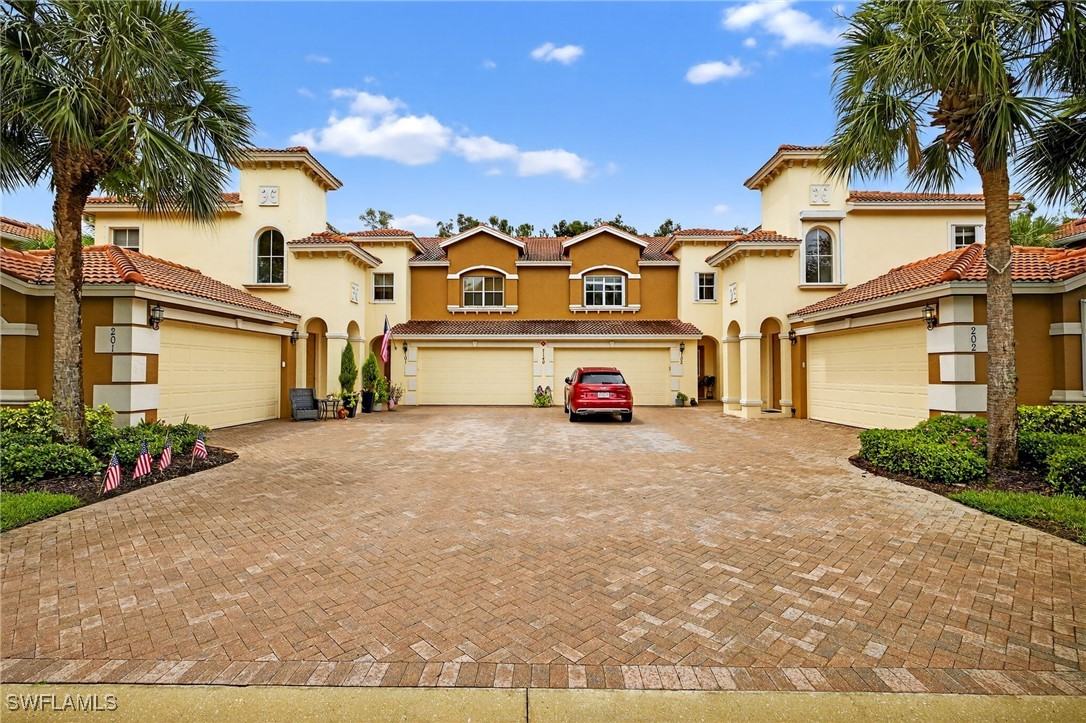 a white house covered with tall trees
