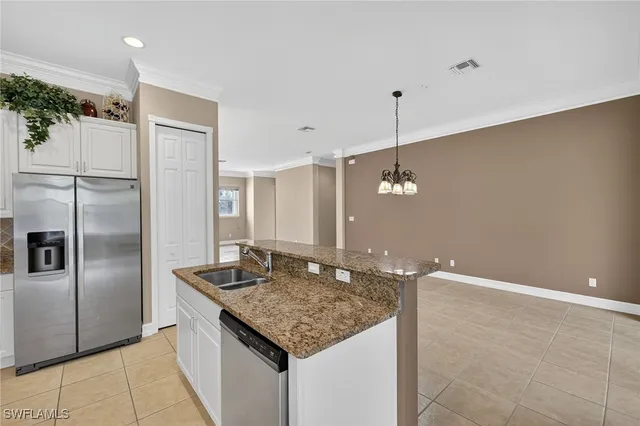 a kitchen with kitchen island a counter top space appliances and cabinets
