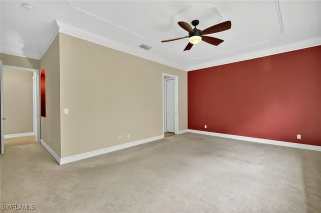 an empty room with closet and ceiling fan