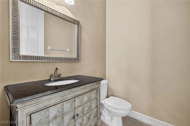 a bathroom with a toilet a sink and mirror