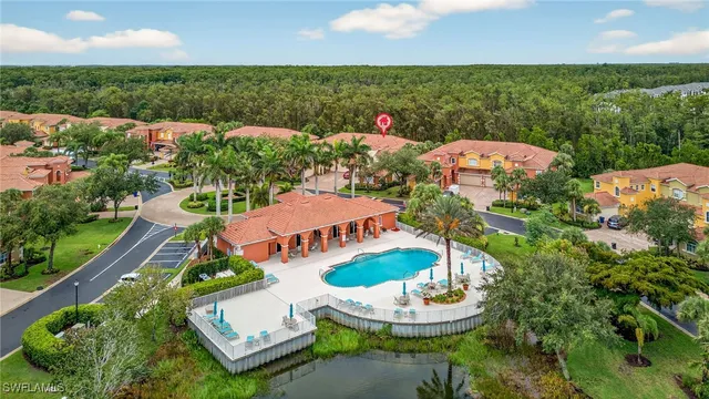 an aerial view of a house with a table chairs and a fire pit